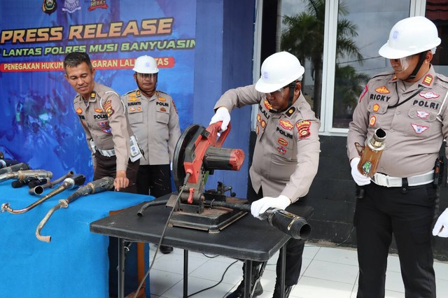 Petugas lalu lintas melakukan pemeriksaan knalpot brong