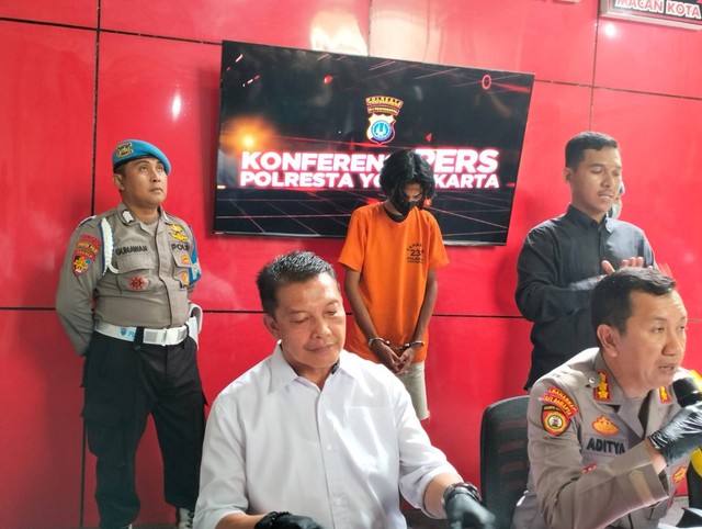 anak tersangka duduk di ruang pemeriksaan polisi