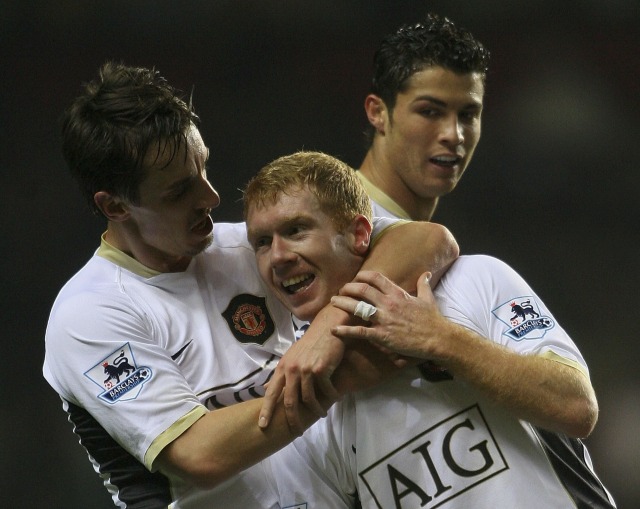 Paul Scholes dipeluk rekan setimnya, Gary Neville, usai mencetak gol ke gawang Aston Villa. (Foto: Stu Forster/Getty Images)