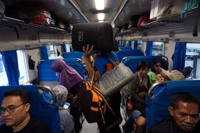Seorang portir sedang mengangkut barang penumpang kereta api. (Foto: Aditia Noviansyah/kumparan)