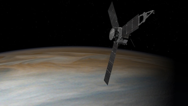 Pesawat Juno dari NASA terbang di atas Jupiter. (Foto: NASA)