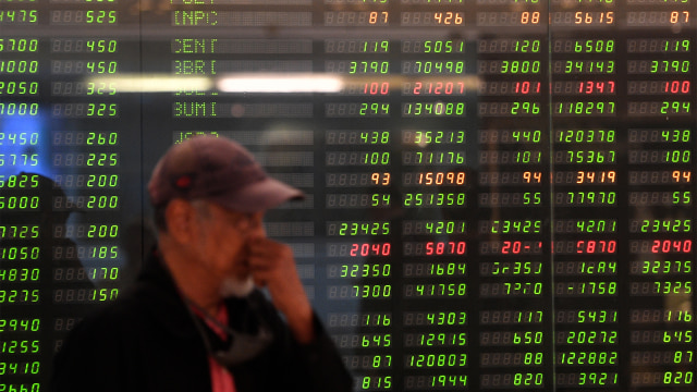 Pekerja membersihkan monitor pergerakan IHSG (Foto: ANTARA FOTO/Sigid Kurniawan)