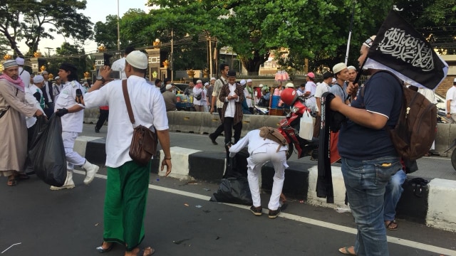 Peserta aksi memunguti sampah sebelum bubar. (Foto: Fachrul Irwinsyah/kumparan)