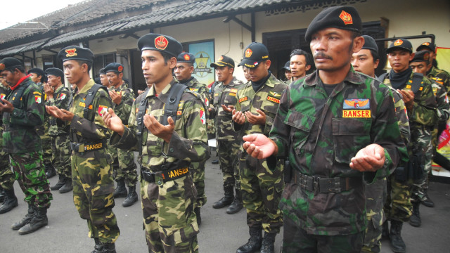 Banser membantu anggota kepolisian. Foto: Antara/Anis Efizudin