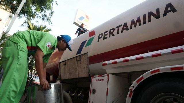 Petugas mengisi bahan bakar bensin. (Foto: Jamal Ramadhan/kumparan)