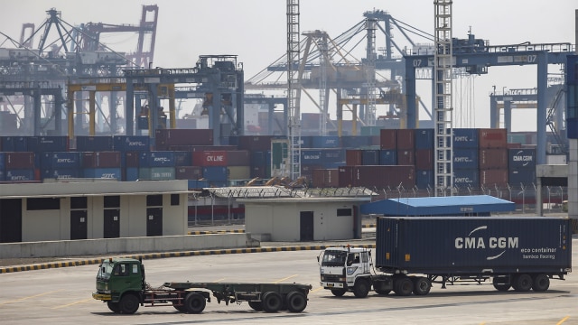 Kendaraan membawa peti kemas dengan latar belakang area bongkar muat di Pelabuhan Tanjung Priok, Jakarta, Rabu (15/8/2018). (Foto: ANTARA FOTO/Muhammad Adimaja)