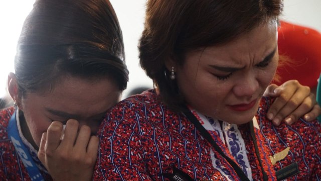 Pramugari Lion Air menangis usai menaburkan bunga. (Foto: Jamal Ramadhan/kumparan)
