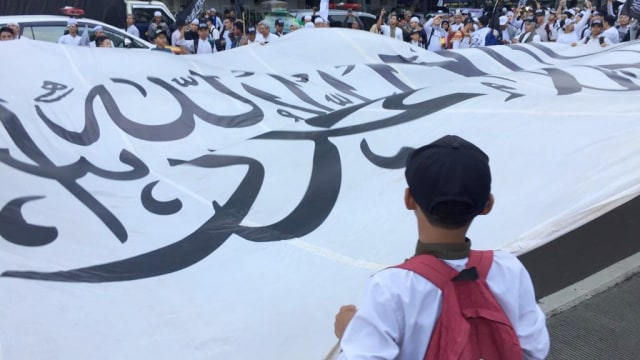 Bendera tauhid raksasa dikibarkan Bundaran Patung Kuda. (Foto: Fachrul Irwinsyah/kumparan)