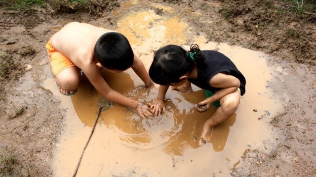 Ilustrasi anak bermain kubangan air (Foto: Shutterstock)