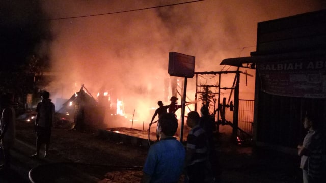 Damkar Kobar bersama warga sekitar memadamkan api di rumah warga Kumai Hilir. (Foto: Damkar Kobar)