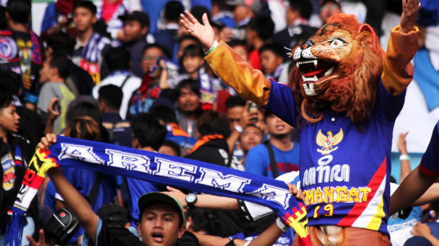 Suporter Arema FC merayakan kemenangan tim kesayangannya atas Bhayangkara FC di Stadion Patriot Candrabhaga. Foto: Risky Andrianto/Antara