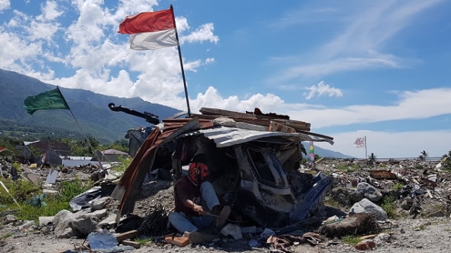 Salah satu warga sedang memotong besi di lokasi likuefaksi Perumnas Balaroa Palu, Sabtu (6/4). Foto: Dok. PaluPoso