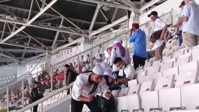 Pendukung pasangan capres dan cawapres no urut 02, Prabowo Subianto-Sandiaga Uno membersihkan sampah setelah kampanye akbar di Stadion Gelora Bung Karno, Minggu, (7/4). Foto: Twitter @UusRsd