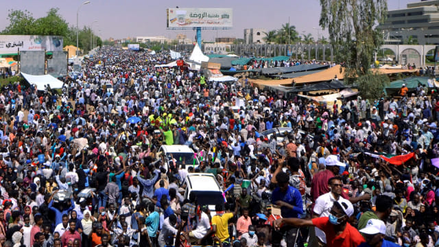 Sejumlah demonstran Sudan meneriakkan protes menuntut Presiden Sudan Omar Al-Bashir untuk mundur di luar kementerian pertahanan di Khartoum, Sudan, Senin, (8/4). Foto: REUTERS/STR