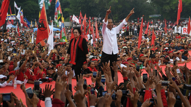 Calon Presiden nomor urut 01 Joko Widodo (kanan) bersama Ketua Umum PDI Perjuangan Megawati Soekarnoputri (kiri) menyapa pendukung saat kampanye akbar di Solo, Jawa Tengah, Selasa (9/4). Foto: ANTARA FOTO/Wahyu Putro A