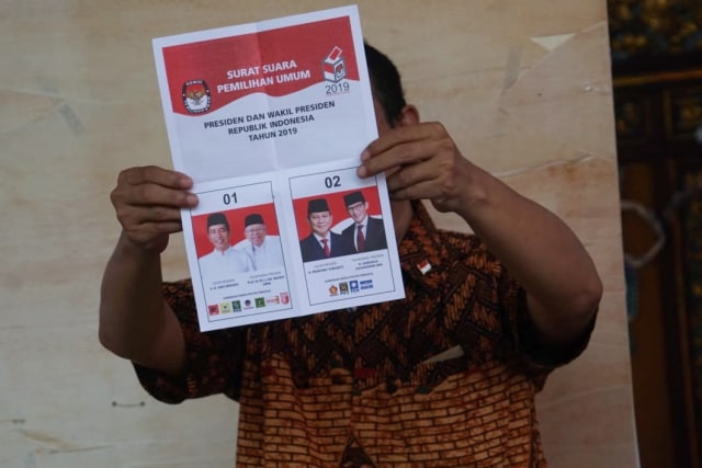 Ilustrasi petugas KPPS yang  sedang memperlihatkan surat suara saat melakukan penghitungan. Foto: Jamal Ramadhan/kumparan