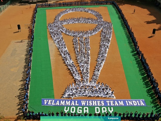 Para siswa membuat formasi trofi Piala Dunia Cricket ICC  sambil melakukan yoga. Foto: REUTERS / P. Ravikumar