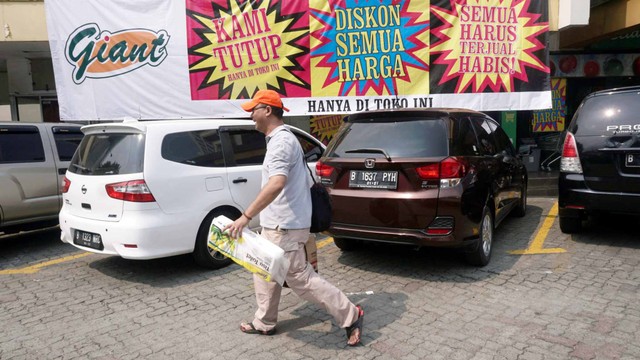 Pengunjung usai berbelanja di Supermarket Giant Ekspres Mampang Prapatan, Jakarta, Minggu (23/6). Foto: Fanny Kusumawardhani/kumparan