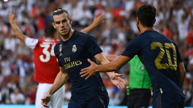 Gareth Bale dan Marco Asensio merayakan gol ke gawang Arsenal. Foto: AFP/Andrew Caballero-Reynolds