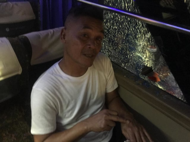 Kaca bus pecah di dekat tempat duduk Pelatih Persiraja, Hendri Susilo, akibat terkena lemparan batu saat pulang menuju hotel dari stadion usai laga melawan Perserang, Senin (2/9). Foto: MO Persiraja