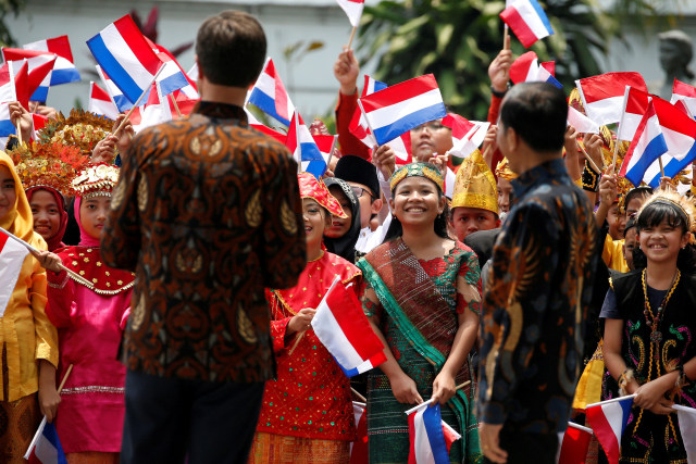 Anak-anak menggunakan baju adat menyambut Perdana Menteri Belanda Mark Rutte  saat melakukan kunjungan ke Istana Presiden di Bogor. Foto: REUTERS/Willy Kurniawan