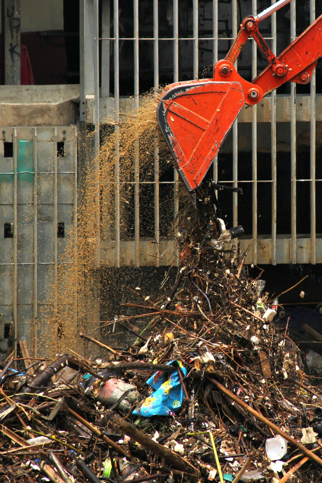 Petugas dibantu alat berat mengangkut sampah dari Pintu Air Manggarai, Jakarta, Rabu (9/10/2019). Foto: Nugroho Sejati/kumparan