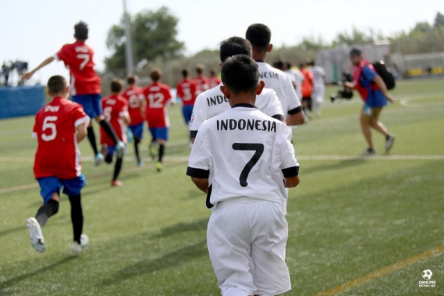 Para pemain Indonesia memasuki lapangan untuk menghadapi Spanyol di turnamen 2019 Danone Nations Cup. Foto: Matthieu Joffres/DNC