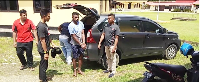 Petugas saat menggiring pelaku dari dalam mobil,foto: Arfat