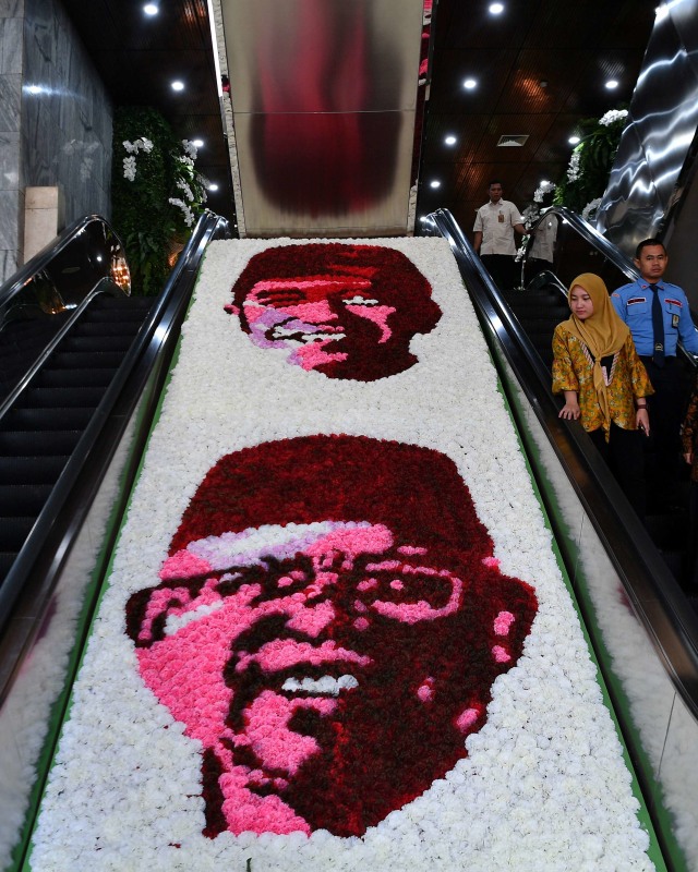 Hiasan bunga bergambar Presiden dan Wakil Presiden terpilih Joko Widodo dan Ma'ruf Amin disela gladi bersih pelantikan di Kompleks Parlemen, Senayan, Jakarta. Foto: ANTARA FOTO/Sigid Kurniawan