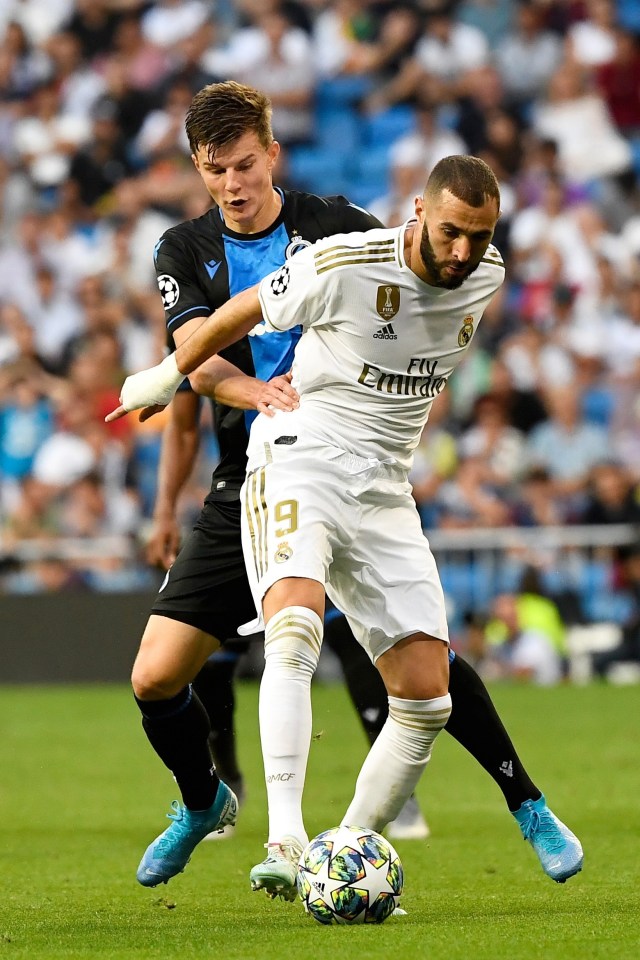Pemain Real Madrid Karim Benzema berebut bola dengan pemain Klub Brugge. Foto: PIERRE- PHILIPPE MARCO/AFP