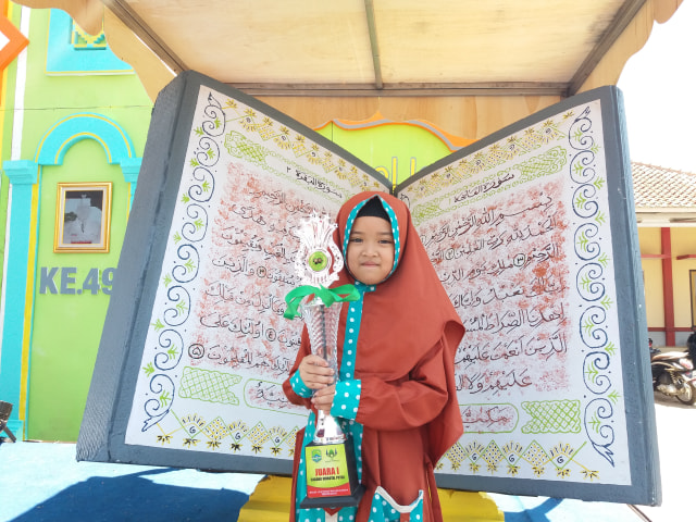 Ahla Ilfatulghina Zakiyah ketika menerima piala pertamanya pada musabaqah tilawatil quran (MTQ) tingkat Kabupaten Majalengka tahun 2019 yang digelar di Kecamatan Malausma, Kabupaten Majalengka, Jawa Barat pada Sabtu (9/11/2019). (Rd Algifari)