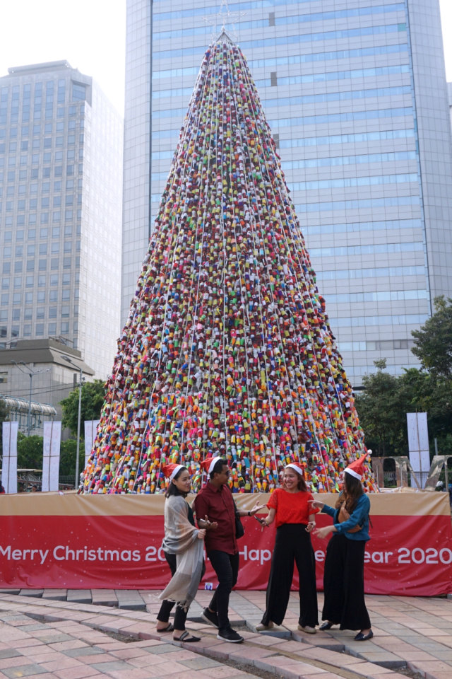 Pengunjung berfoto di depan pohon Natal dari miniatur ondel-ondel yang terbuat dari botol minuman bekas di Thamrin, Jakarta, Sabtu (21/12). Foto: Fanny Kusumawardhani/kumparan