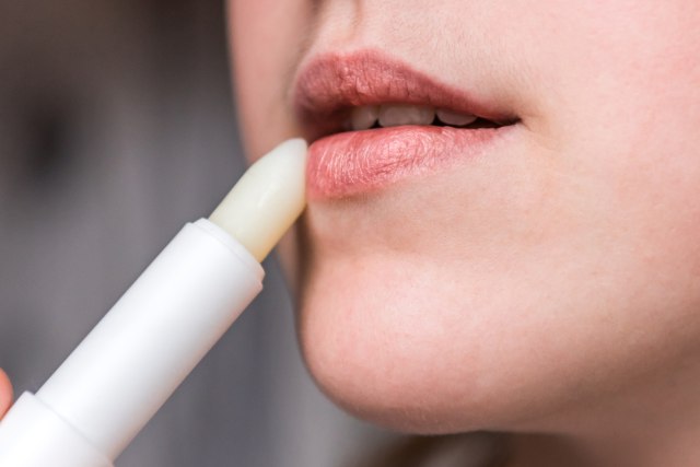 Menggunakan lip balm untuk melembabkan bibir Foto: Shutter Stock
