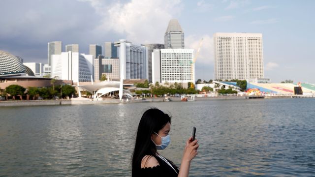 Salah satu wisatawan berkunjung ke Merlion Park di Singapura setelah penetapan status level oranye.
 Foto: REUTERS/Feline Lim