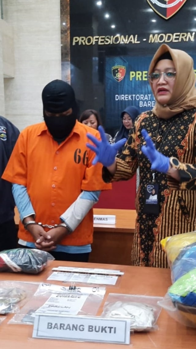 Penyidik Bareskrim tunjukkan tersangka beserta barang bukti kasus pelatih pramuka cabul di Tuban, Jumat (21/2). Foto: Ricky Febrian/kumparan