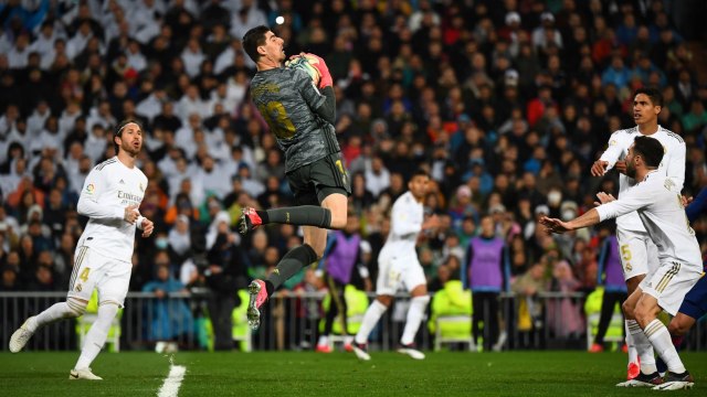 Thibaut Courtois melakukan penyelamatan di laga Real Madrid vs Barcelona. Foto: GABRIEL BOUYS / AFP