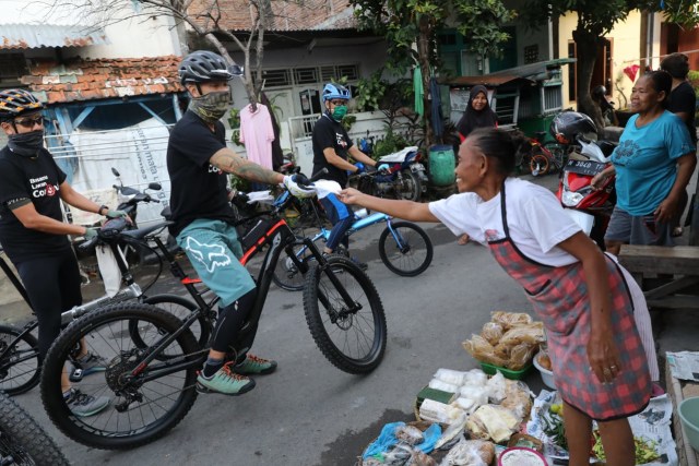 Gubernur Jateng, Ganjar Pranowo, membagikan masker pada warga usai bersepeda, Rabu (8/4/2020). Foto: ari.