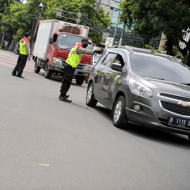 Polisi melakukan imbauan kepada pengendara mobil untuk dapat mematuhi penerapan Pembatasan Sosial Berskala Besar (PSBB) di kawasan Menteng, Jakarta (11/4). Foto: ANTARA FOTO/Nova Wahyudi