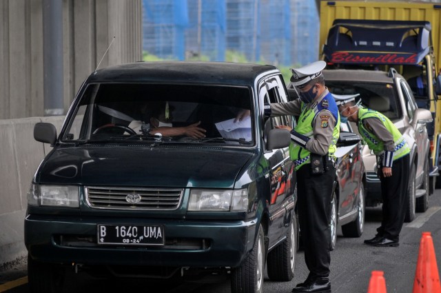 Petugas Kepolisian mengecek identitas mobil pribadi yang melintasi tol Jakarta-Cikampek di Cikarang Barat, Kabupaten Bekasi, Jawa Barat, Sabtu (9/5). Foto: ANTARA FOTO/ Fakhri Hermansyah