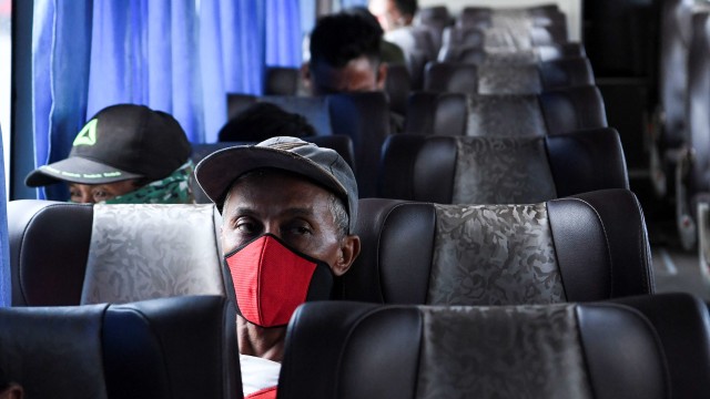 Penumpang Bus AKAP (antar kota antar provinsi) yang dilarang berpergian bersiap dikembalikan di Terminal Pulogebang, Jakarta. Foto: ANTARA FOTO/Hafidz Mubarak A