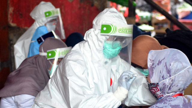 Petugas medis dari Dinas Kesehatan Kota Bogor melakukan tes swab kepada pedagang di Pasar Baru Bogor, Jawa Barat. Foto: ANTARA FOTO/Arif Firmansyah