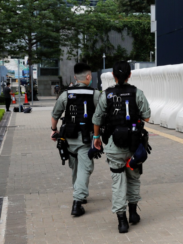 Polisi anti huru-hara berjaga di luar kantor anggota dewan Hong Kong. Foto: REUTERS / Tyrone Siu
