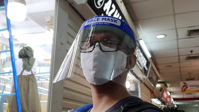 Pedagang menggunakan faceshield mengikuti protokol kesehatan selama berjualan di Pasar Tanah Abang Blok A Pintu Timur, Senin (15/6). Foto: Livia Kristianti/ANTARA
