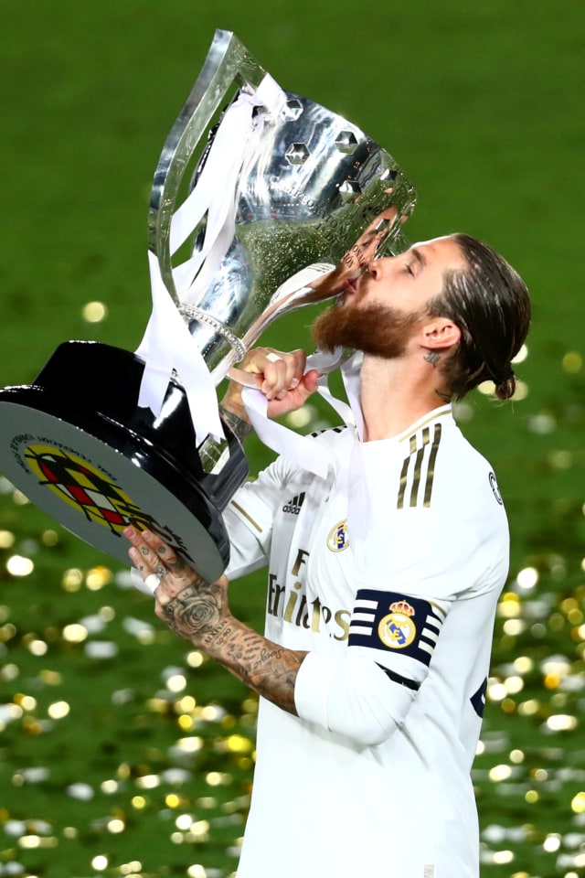 Pemain Real Madrid Sergio Ramos mencium piala kemenangan pada La Liga Santander di Stadion Alfredo Di Stefano, Madrid, Spanyol, (16/7). Foto: Sergio Perez REUTERS