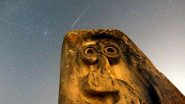 Sebuah meteor melesat melewati bintang-bintang di langit, di atas batu nisan abad pertengahan saat hujan meteor Perseid di Radimlja dekat Stolac, Bosnia dan Herzegovina, Rabu (12/8). Foto: REUTERS / Dado Ruvic