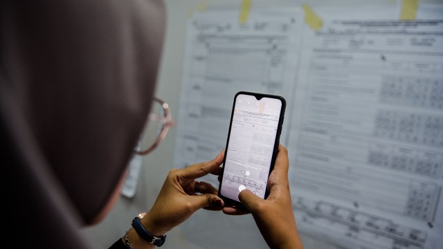 Petugas memotret lembar C-KWK saat uji coba Sistem Informasi Rekapitulasi (Sirekap) pemilihan serentak di SOR Volly Indoor Stadion Si Jalak Harupat, Kabupaten Bandung, Jawa Barat, Rabu (9/9/2020). Foto: M AGUNG RAJASA/ANTARA FOTO