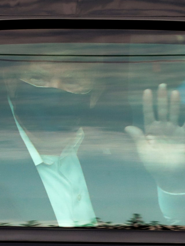 Presiden AS Donald Trump melambai kepada para pendukungnya saat ia berkendara sebentar dalam iring-iringan kepresidenan di depan Pusat Medis Militer Nasional Walter Reed, tempat ia dirawat karena penyakit virus corona. Foto: Cheriss May/Reuters