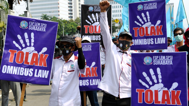 Massa aksi membawa poster saat melakukan aksi unjuk rasa menolak Undang-Undang Cipta Kerja di kawasan Patung Kuda, Jakarta, Rabu (28/10). Foto: Hafidz Mubarak A/ANTARA FOTO