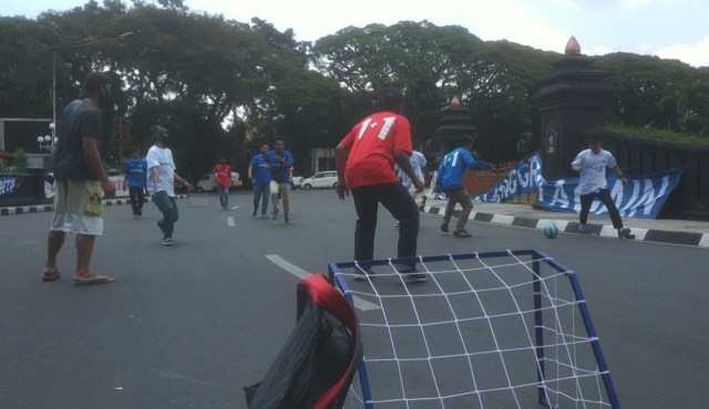 Street Football yang digelar Aremania di tengah unjuk rasa aksi damai menuntut penuntasan konflik dualisme Arema, di depan Balai Kota Malang, pada Senin (16/11/2020). Foto: Ulul Azmy