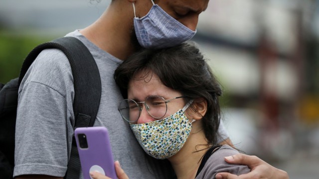 Kerabat pasien COVID-19 menunggu di luar di rumah sakit 28 de Agosto, di Manaus, Brasil, Kamis (14/1). Foto: Bruno Kelly/REUTERS